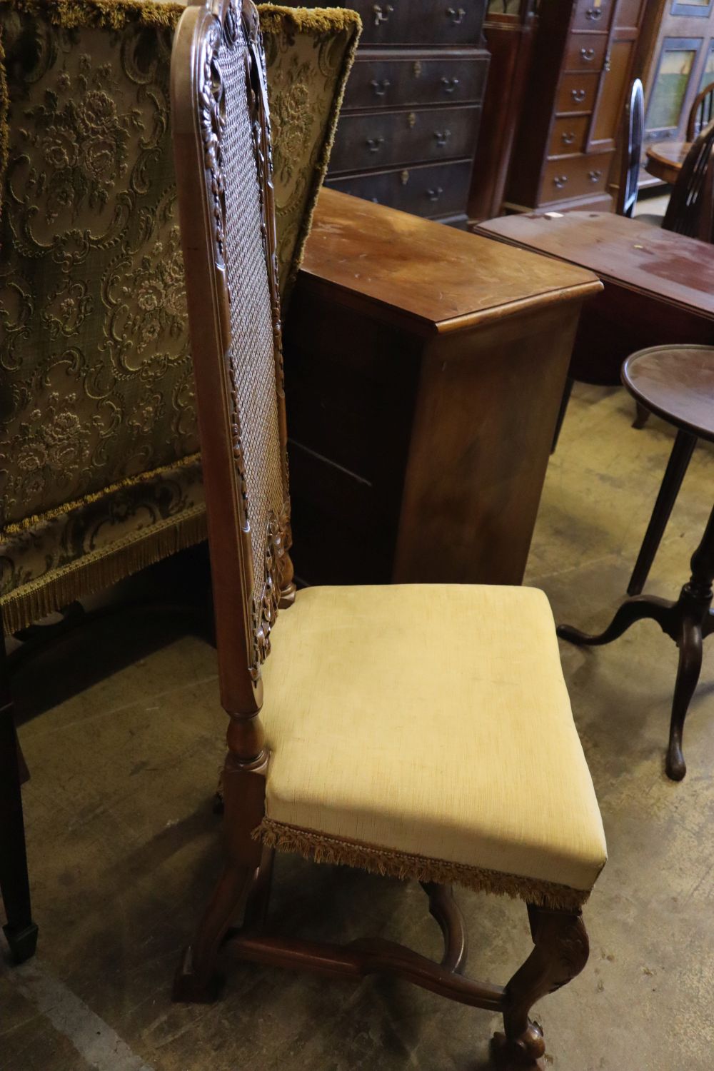 A 19th century Flemish style carved walnut armchair, upholstered in brocade and a Georgian style caned walnut dining chair